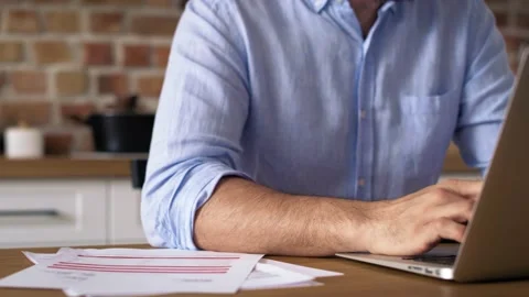 Close up video of man working on a laptop at home.  Stock-Footage 156734450