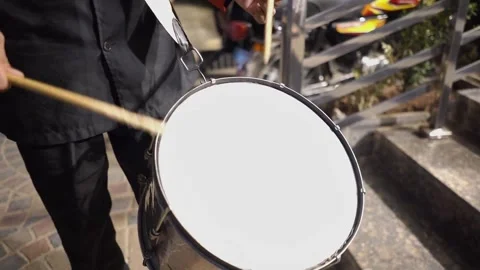 Close-up video of a marching band drummer playing a traditional drum during a we 스톡 동영상 343608397