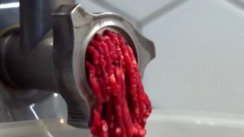 Close-up video of meat grinder with minced meat scrolled out of it. Quick video Stock Footage 166344856
