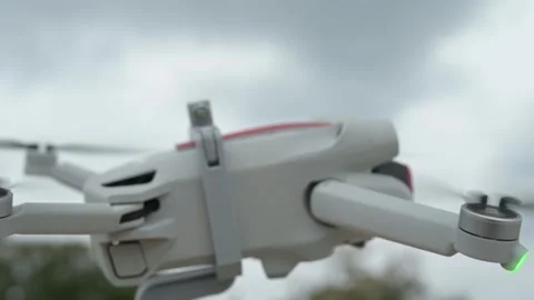 Close-up video of a modern drone preparing for flight, propellers spinning in Stock Footage 319559781