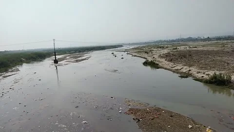 Close up video of polluted river water and unused land in the river bed. Stock Footage 144912010