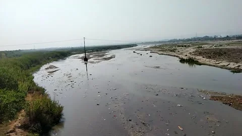 Close up video of polluted river water and unused land in the river bed. Stock Footage 144912019