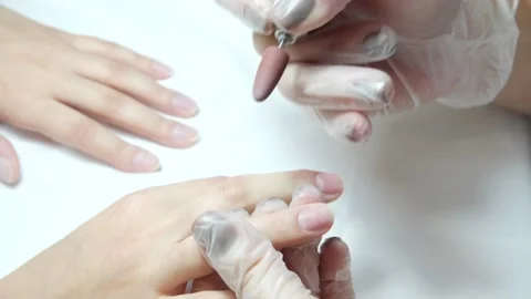 Close-up video of professional processing of nails and finger skin with a Video stock 146630100