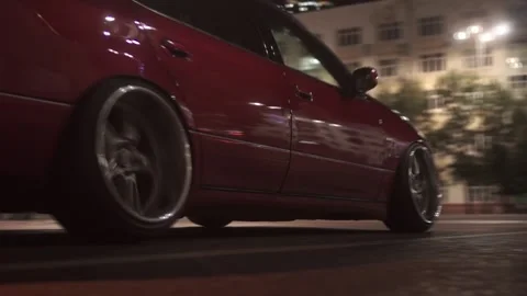 Close up video of red modern tuning a car on the city street. Footage. The car Stock-Footage 144730008