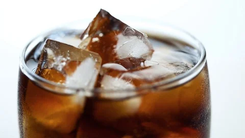 Close up video of rotating glass with cola and ice Selective focus HD Stock Footage 112006284