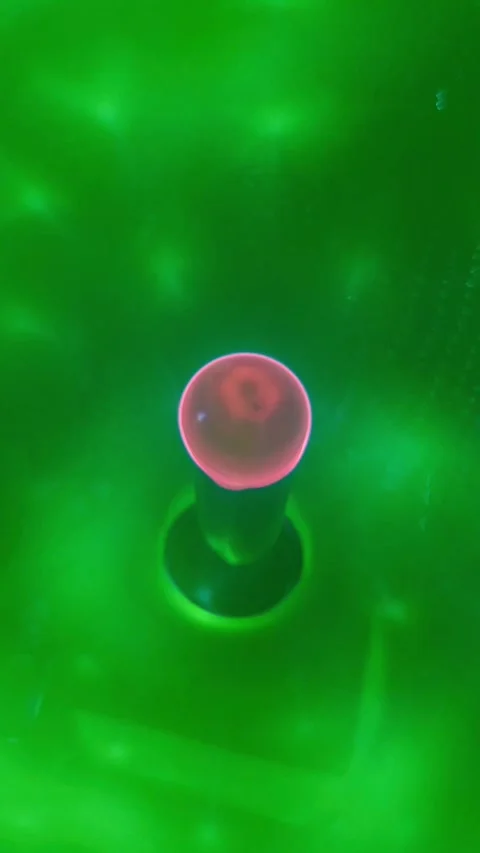 Close up video of a rotating pink and green plasma ball emitting glowing. Stock Footage 345289879