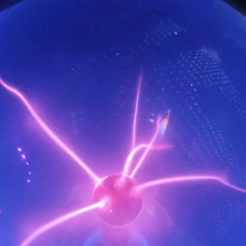 Close up video of a rotating red plasma ball emitting glowing electrical en.. Stock Footage 345289858
