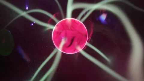 Close up video of a rotating red plasma ball emitting glowing electrical. Stock Footage 345289872