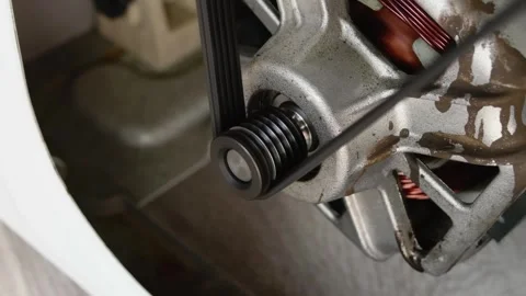 Close-up video of a rotating washing machine motor. Washing machine repair .. Stock Footage 287297863