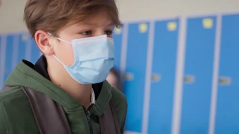 Close up video of schoolboy in protective mask the corridor. Stock Footage 153148454