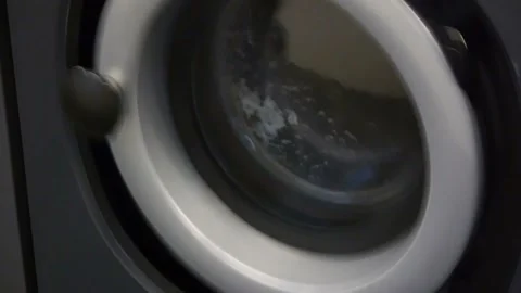 Close-up video of self-service laundry - coin laundrywashing machines and Stock Footage 105672452