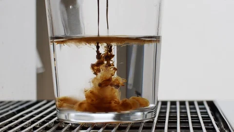 Close up video shot of coffee-machine pouring espresso in glass cup slow motion. Stock Footage 116410669