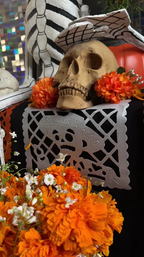 Close-up video shot of prop skull on papel picado. Day of the dead Altar Stock Footage 294366624