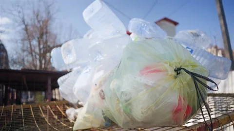 Close up video showing an overflowing trash can with plastic bottles and a .. Video stock 339644412