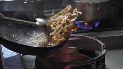 Close up video in slow motion of chinese food cooking in a wok Stock-Footage 307916428