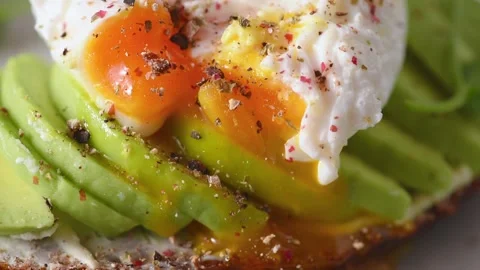Close up video sprinkle pepper on poached egg and over avocado toast Video stock 171721740
