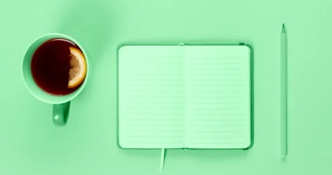 Close up video on tea cup and fancy notebook with empty or blank pages on desk Stock Footage 269455198
