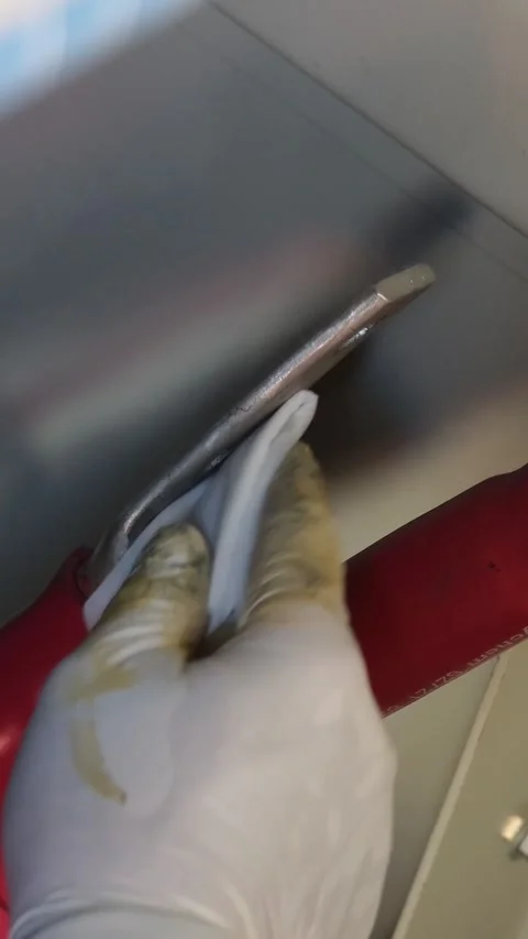 Close up video of a technician hand in white glove using a cloth to wipe. Stock Footage 338355313