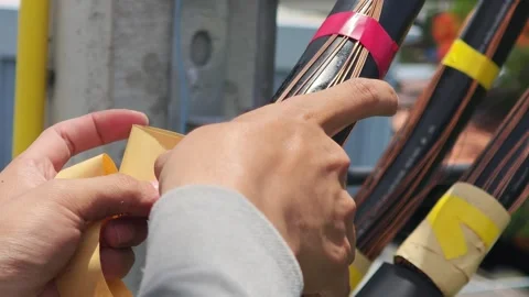 Close up video of a technician hand wrapping mastic sealant tape. 库存影片 340278023