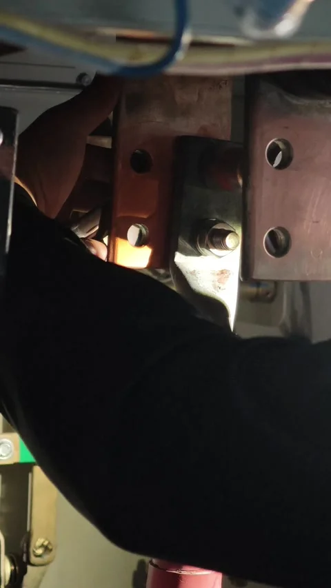 Close up video of a technician hands using a wrench to tighten a heavy duty. Stock Footage 338298505