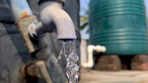 Close up video of water coming out and falling from an old plastic tap in s.. Stock Footage 270077697