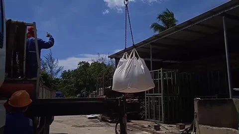 Close-up Video of White Sacks Filled with Sand Lifted into Truck by Crane Stock Footage 304610402