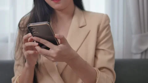 Close-up video of a woman using a mobile phone to surf various websites. Stock Footage 198112005