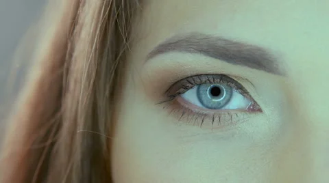 Close up video of woman's blue eye in studio Stock Footage