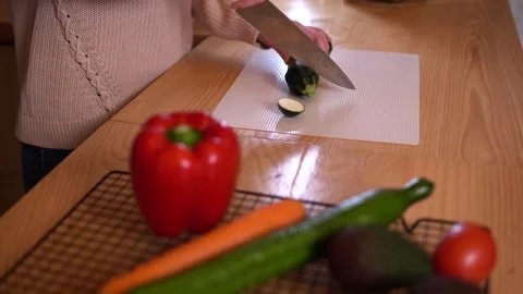 Close-up video of woman’s hands chopping a green zucchini Video stock 308768184