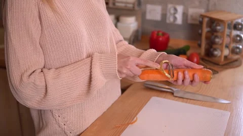 Close-up video of woman’s hands peeling a carrot Stock Footage 308769621