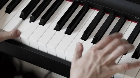 Close-up video of woman's hands playing exercises on the piano Stock Footage 281572099