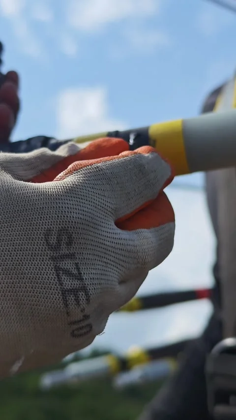 Close up video of worker hands in safety gloves applying semiconducting. Stock Footage 345129097