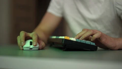 Close-up video of young man hands typing on mechanical keyboard and using Stock Footage 342764092