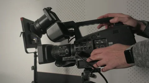 Close-up of a videographer adjusting audio levels 스톡 동영상 335143494
