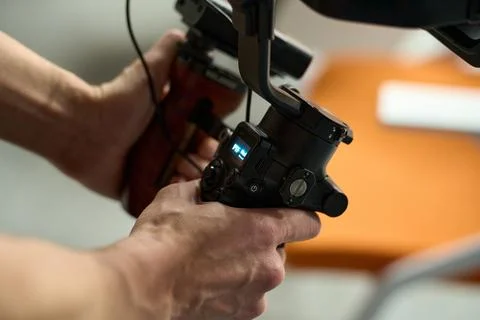 Close-Up of Videographer Operating Gimbal Camera Stock Photos