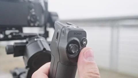 Close up of videographer Pressing Record Button on DJI RS 5 Briefcase Handle Stock Footage 332778227