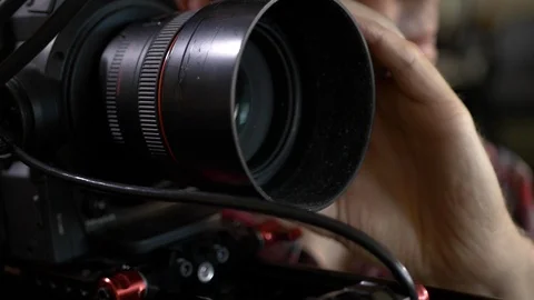 Close up of a videographer's hands focusing during a video production shoot. Stock Footage 99426403