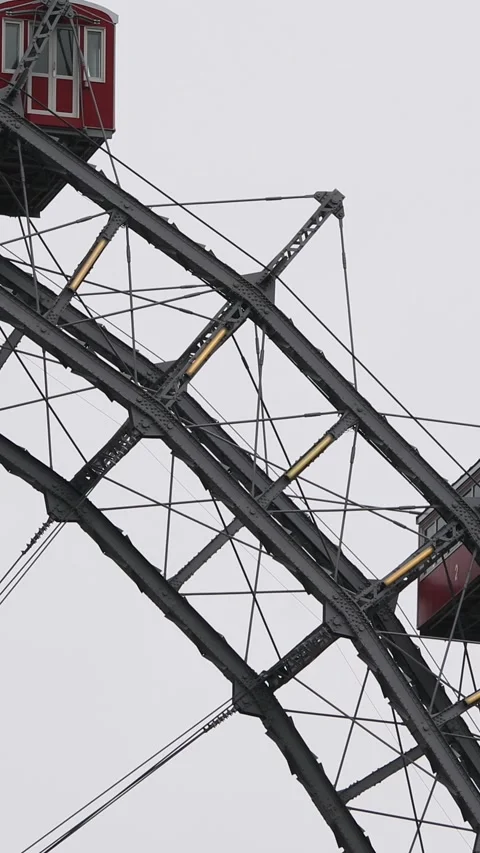Close-up of Vienna Ferris Wheel's red gondolas on a cloudy day Stock Footage 305459153