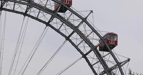 Close-up of Vienna Ferris Wheel's red gondolas on a cloudy day Stock Footage 307167165
