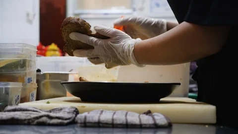 Close up of vietnamese cook buttering up slice of bread to complete a sandwich Stock Footage 147349728