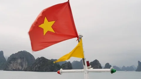 Close up of vietnamese flag waving in strong wind on cruise ship on foggy day Stock Footage 147361032