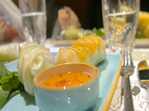 Close-up vietnamese sauce and spring rolls nem on table in restaurant Stock-Footage 81531316