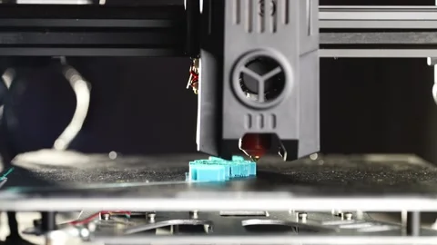 A close-up view of a 3D printer in action printing a plastic component Video stock 313532780