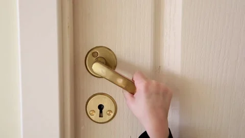 Close up view of 4 year old girl kid opening slowly home door handle. Stock Footage 149313816