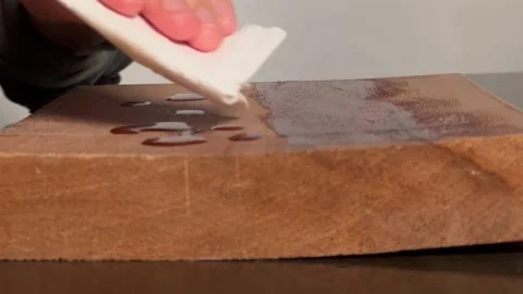 Close-up view about drizzle oil on the wood board and wear oil on wood board Stock Footage 176617992
