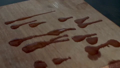Close-up view about drizzle oil on the wood board and wear oil on wood board Видео 176618058