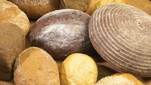 Close-up. View from above. Bread of different kinds is spinning on the table Stock Footage 76426642