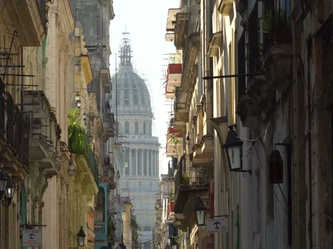 Close-up view above central bright street lit with sun onto old colonial Havana Stock Footage 69784539