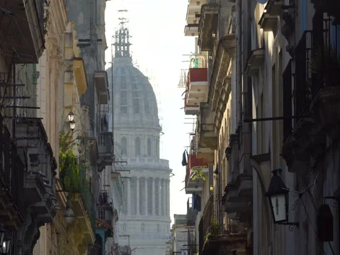 Close-up view above central bright street lit with sunset onto old colonial Stock Footage 69791647