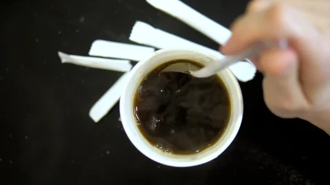 Close-up. view from above. female hand stir sugar in coffee in a disposable cup Stock Footage 111347548